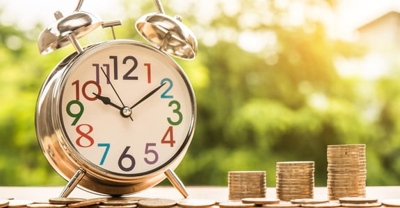 Die Zeit läuft: Symbolbild mit Uhr und Geldmünzen für die Dringlichkeit der GOÄ-Reform.